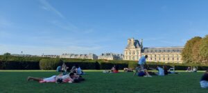 Serene moment at Louvre Gardens where people leisurely relax, surrounded by the city's timeless beauty.
